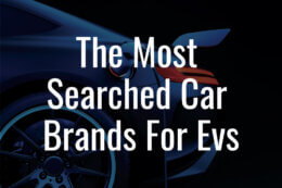 An EV car charging in front of a dark background with the title overlay reading "The Most Searched Car Brands For EVs"