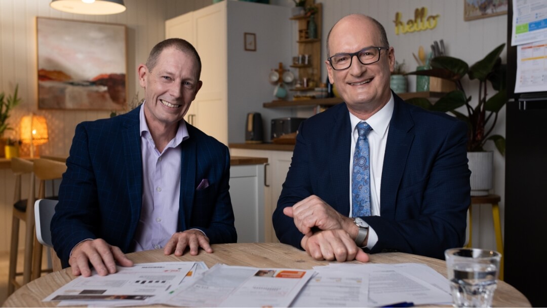 Rob and Kochie sit in front the table