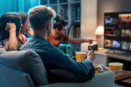 Friends watching TV on an energy efficient appliance