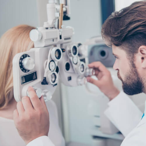 Woman gets eye test with optical health insurance