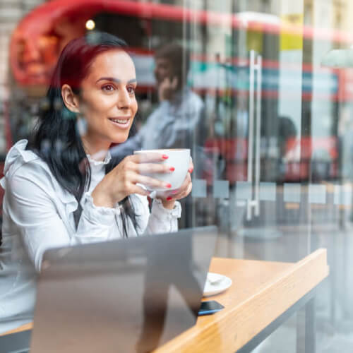 Working woman drinking coffee in London UK