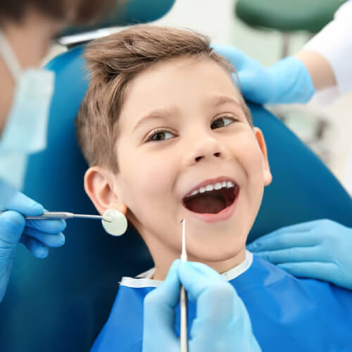 Boy with dental cover visits the dentist