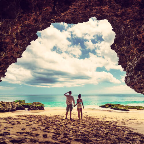A couple by a seaside cave Bali Indonesia