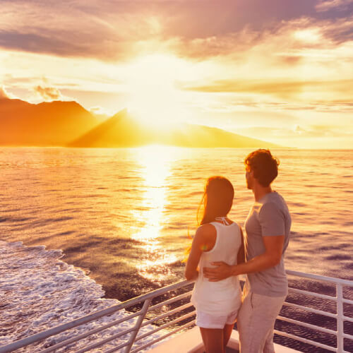 Couple with cruise cover watching a sunset