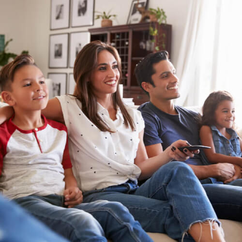 Family watching TV during the day