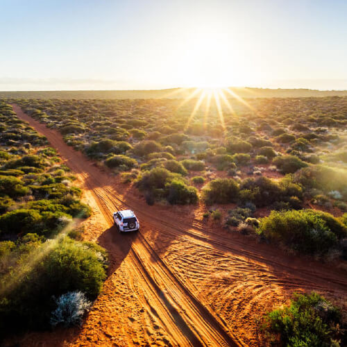 Car driving in outback with domestic travel insurance