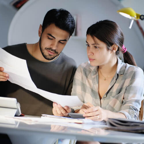 couple looking over the Medicare Levy