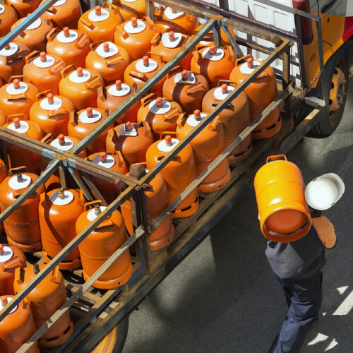 Man delivering liquid natural gas cyclinders