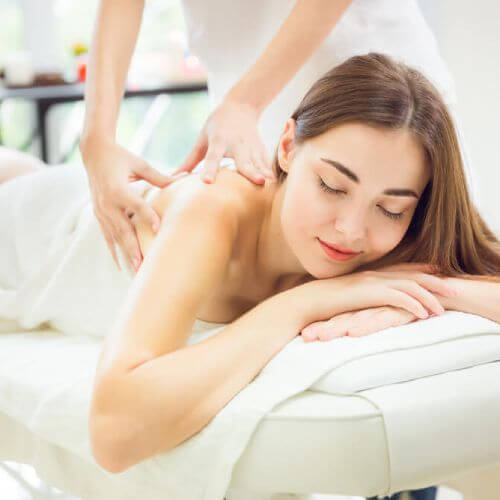 Woman receives massage with private health insurance