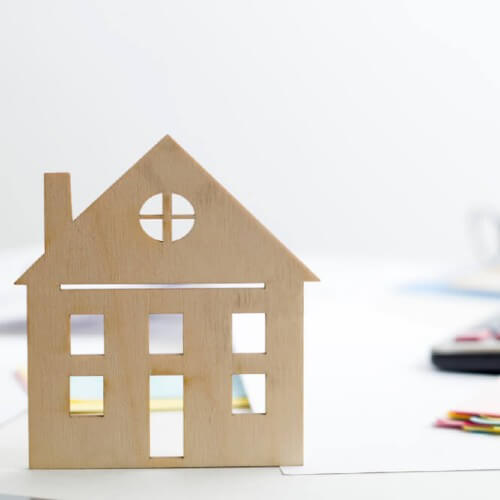 wooden house with calculator 