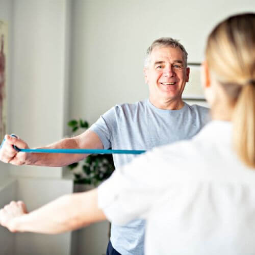 Man exercising with physiotherapist