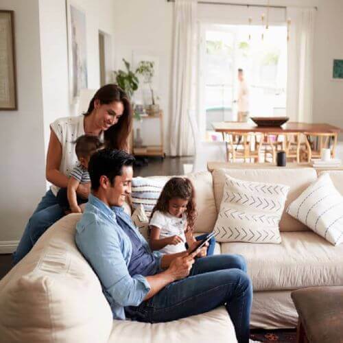 Family relaxes in new home with mortgage insurance