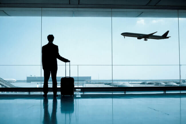 Business person at airport with suitcase