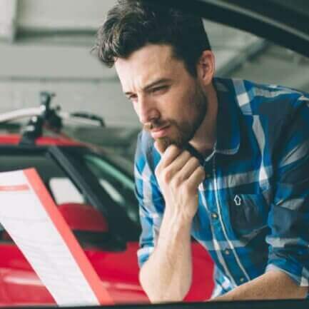 man reading car insurance policy features