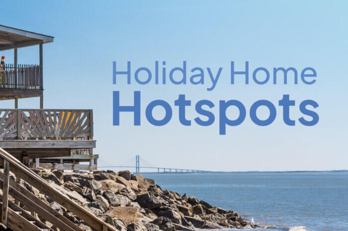 A shot of a house at a waterside location with the title "Holiday Home Hotpots"