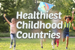 children playing with a kite in a park with a title overlay reading "Healthiest Childhood Countries"