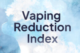 A person smoking an e-cigarette blows smoke out. The words Vaping Reduction Index is present.