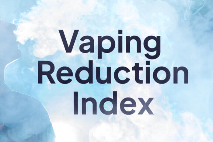 A person smoking an e-cigarette blows smoke out. The words Vaping Reduction Index is present.